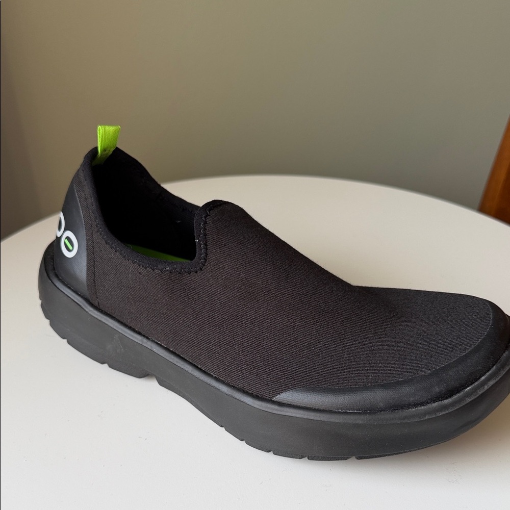 OOFOS Black Slip-On Comfort Shoe with Neon Green Pull Tab
